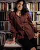 Side profile of balloon sleeve dobby shirt with off-centre buttons and relaxed fit, styled for book lovers.