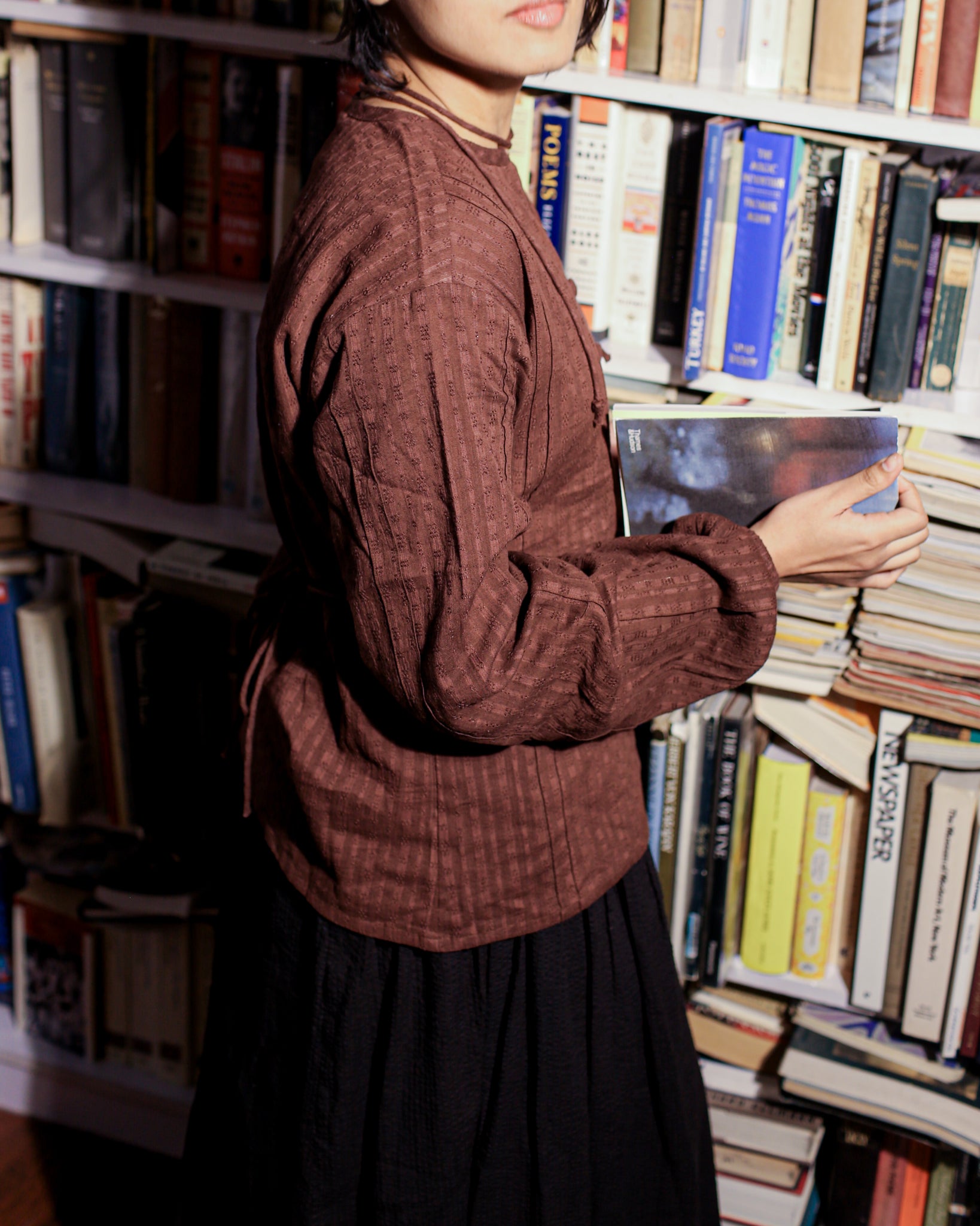Cotton dobby shirt in earthy brown with long gathered sleeves and back-tie silhouette, perfect for literature-inspired styling.