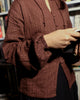 Detailed shot of self-textured dobby sleeve with soft elastic cuff and fabric pintucks, styled with vintage book.