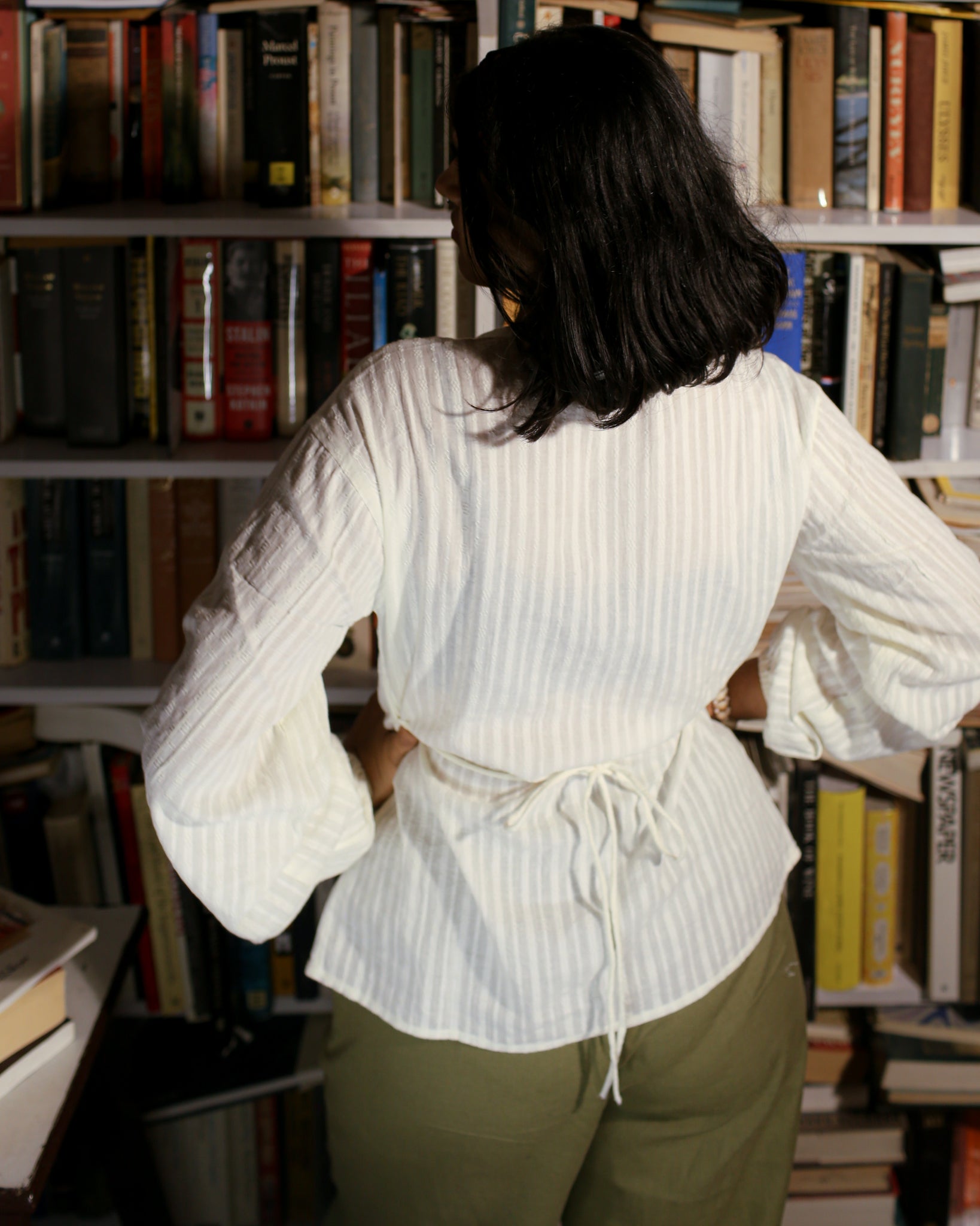 Model wearing vintage string shirt with waist tie and off-centre placket in cotton dobby fabric