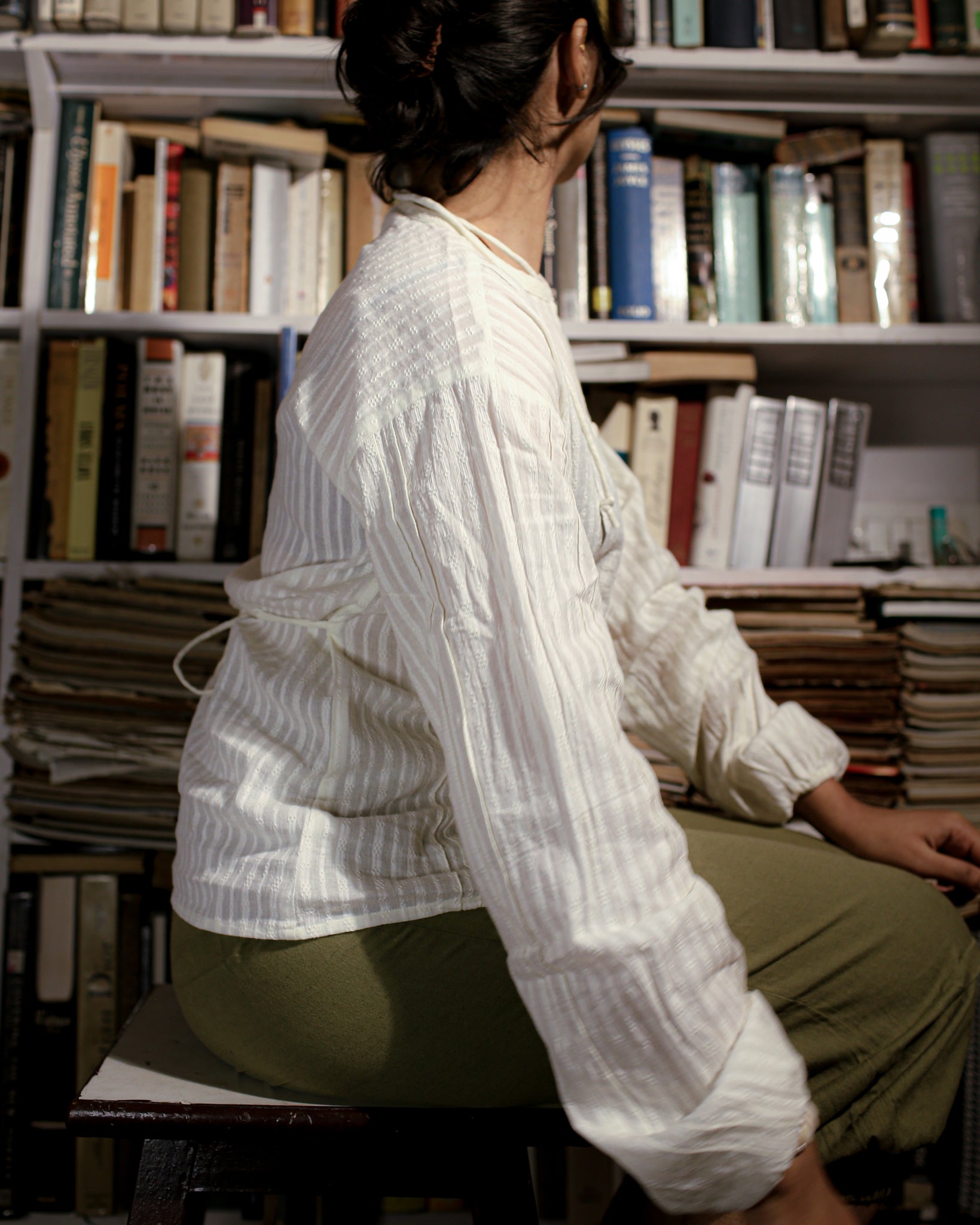 Ivory white shirt with Edwardian sleeves and peekaboo placket, styled casually with loose pants