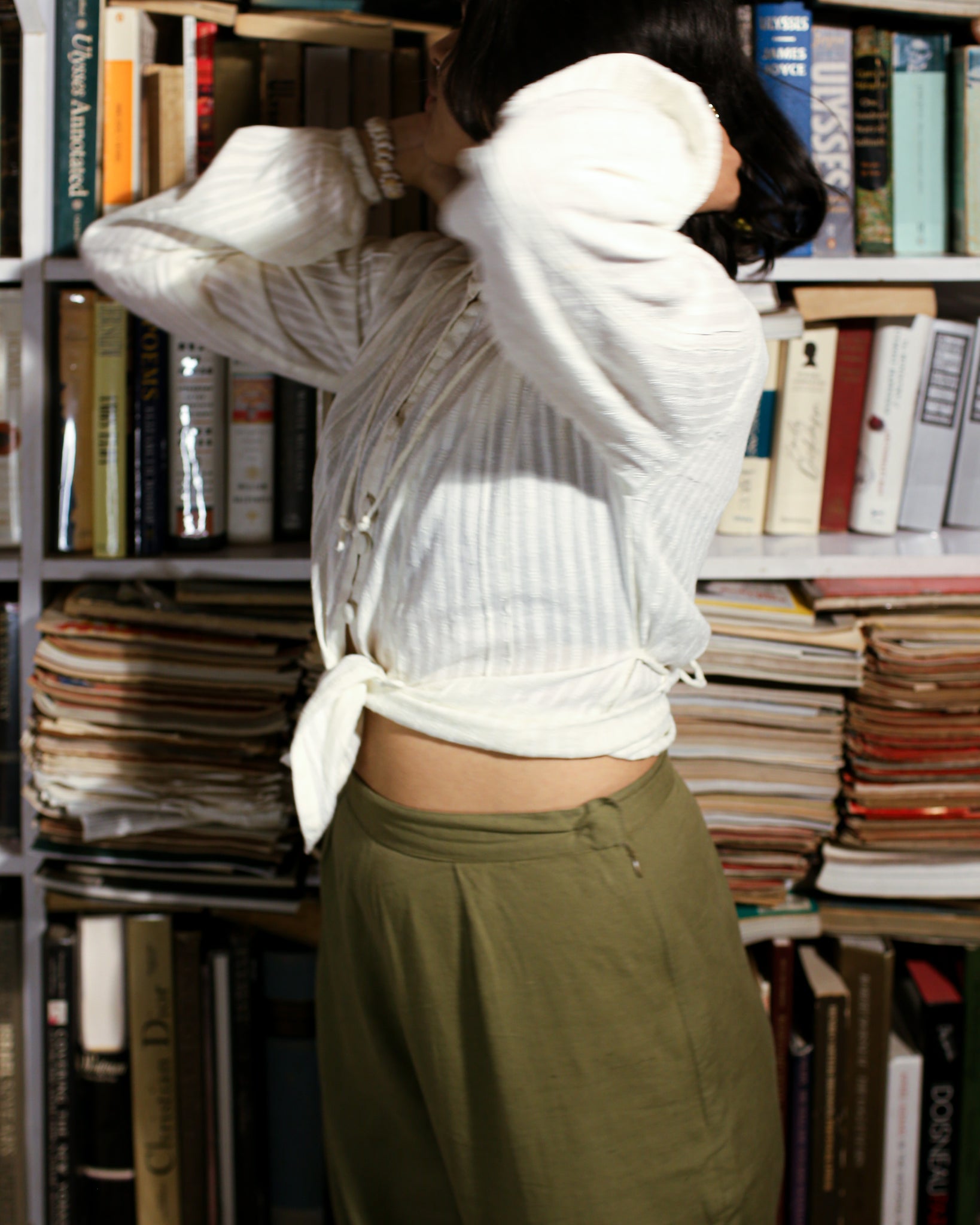 Relaxed fit white cotton shirt with off-shoulder balloon sleeves styled with olive pants.
