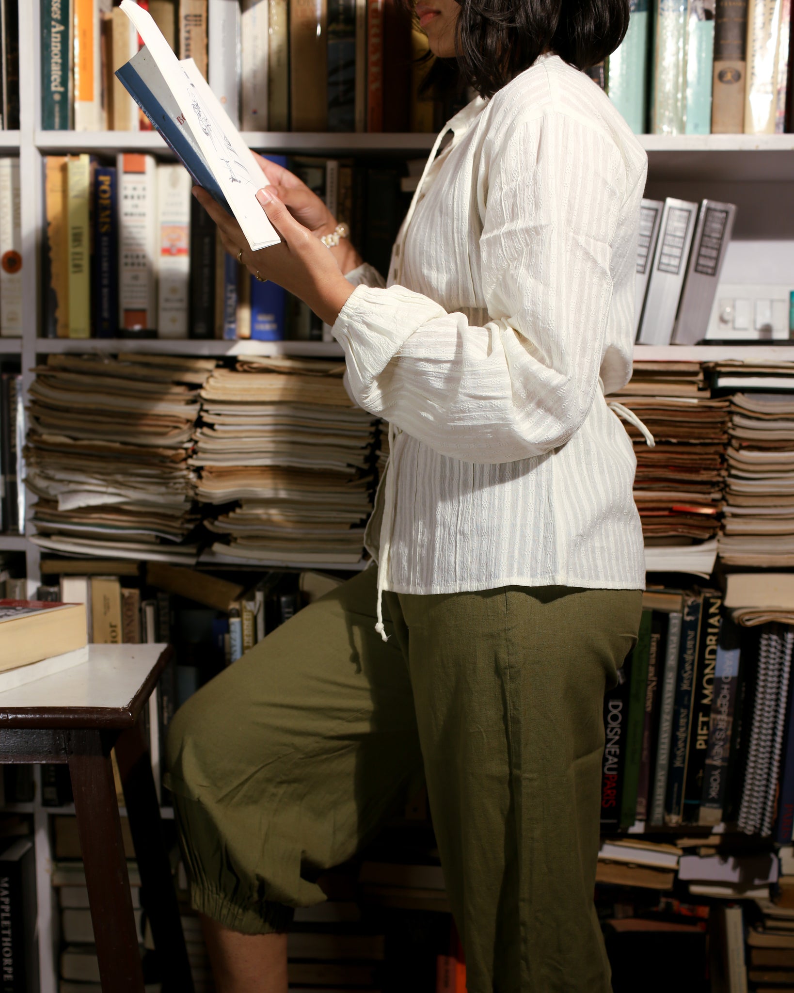 Side profile of white dobby shirt showing smocked sleeves and soft gathered volume at wrist