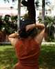 Rear view of sleeveless fitted top with high back neckline in brushed cotton, earthy toned for timeless comfort.