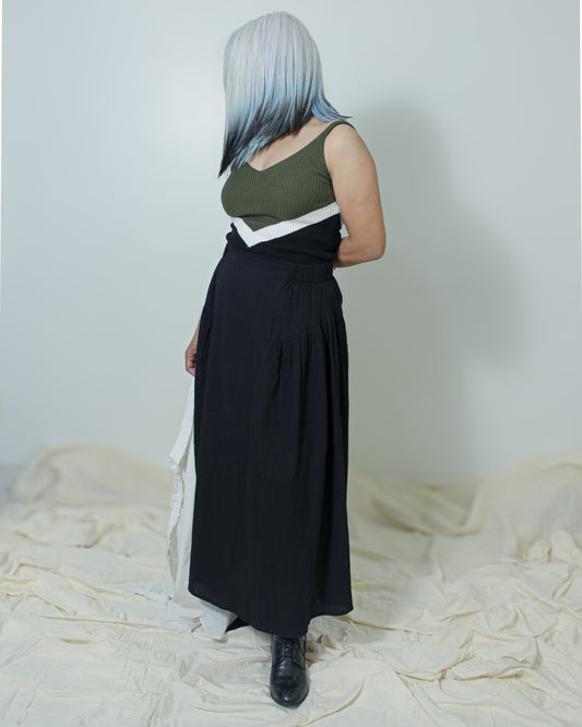 Black high-waist cotton skirt with gathered side panels and flat front.