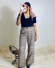 black scallop neck sweater styled with high-waisted trousers.