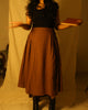 Rustic brown high-waist cotton skirt with gathered side panels and flat front.