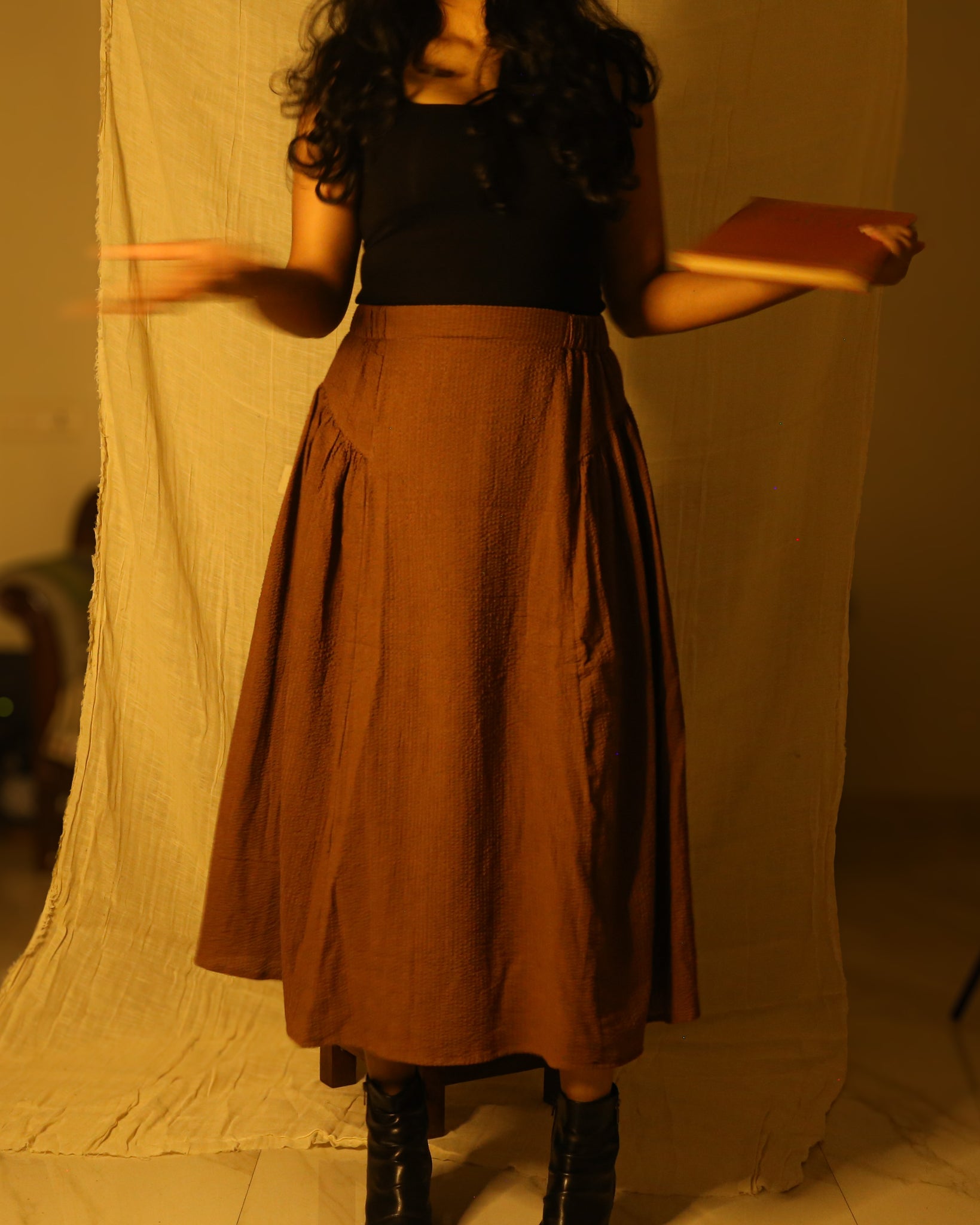 Rustic brown high-waist cotton skirt with gathered side panels and flat front.