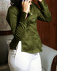 Close-up of mother of pearl square buttons on olive green fitted satin shirt with sharp collar.