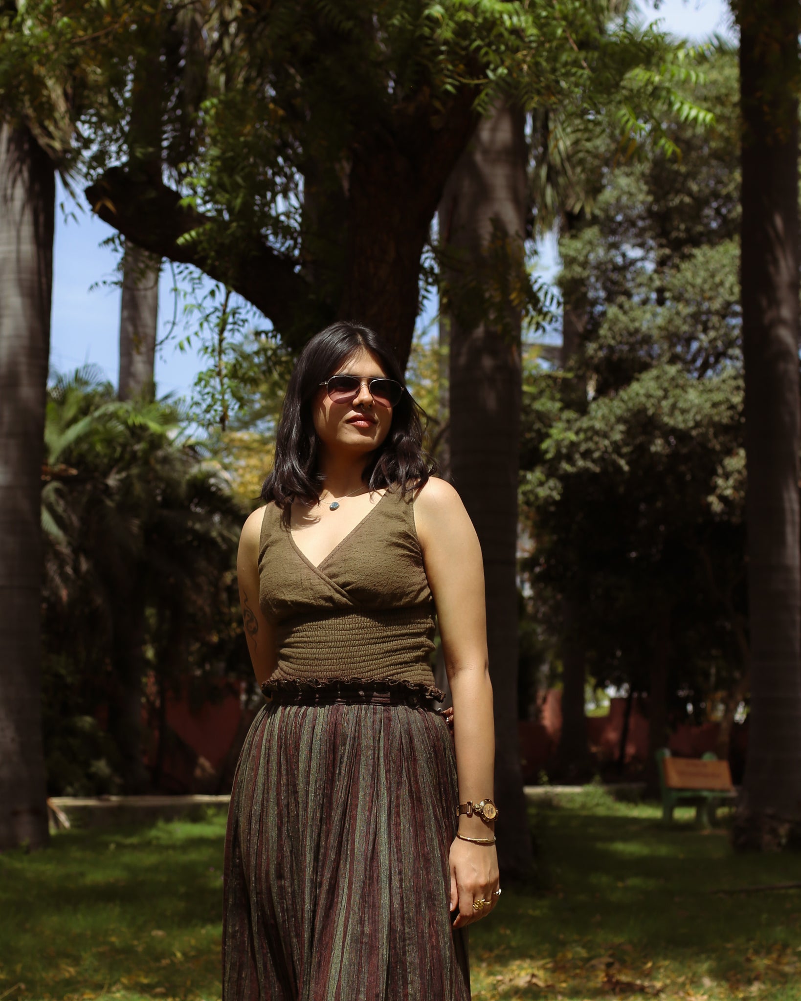 Model in brushed cotton mossbark top with snug smocked waist and earthy brown tones.