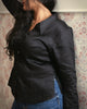 Black shirt in motion, styled for a chic office or day-to-evening look with soft shine and sculpted silhouette.