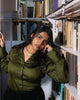Olive green shirt styled in vintage study space, fitted design with pointed collar and flattering waist darts.