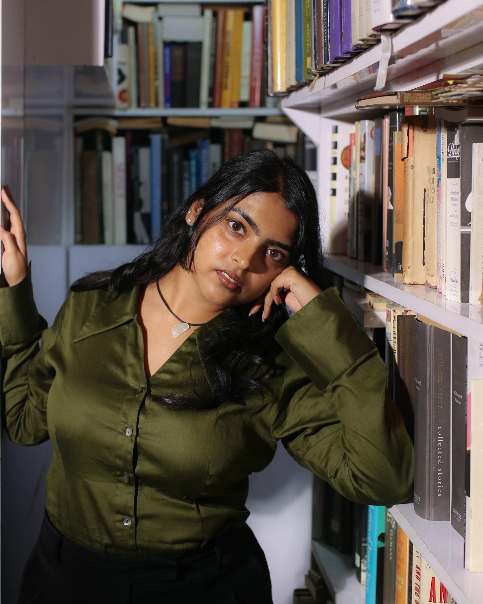 Olive green shirt styled in vintage study space, fitted design with pointed collar and flattering waist darts.