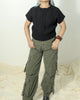 Model styling a black wool sweater in 100% pure wool with cargo for a casual winter look.