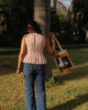 Back view of cotton peplum top with fine pleating from shoulder to waist and relaxed flared hem
