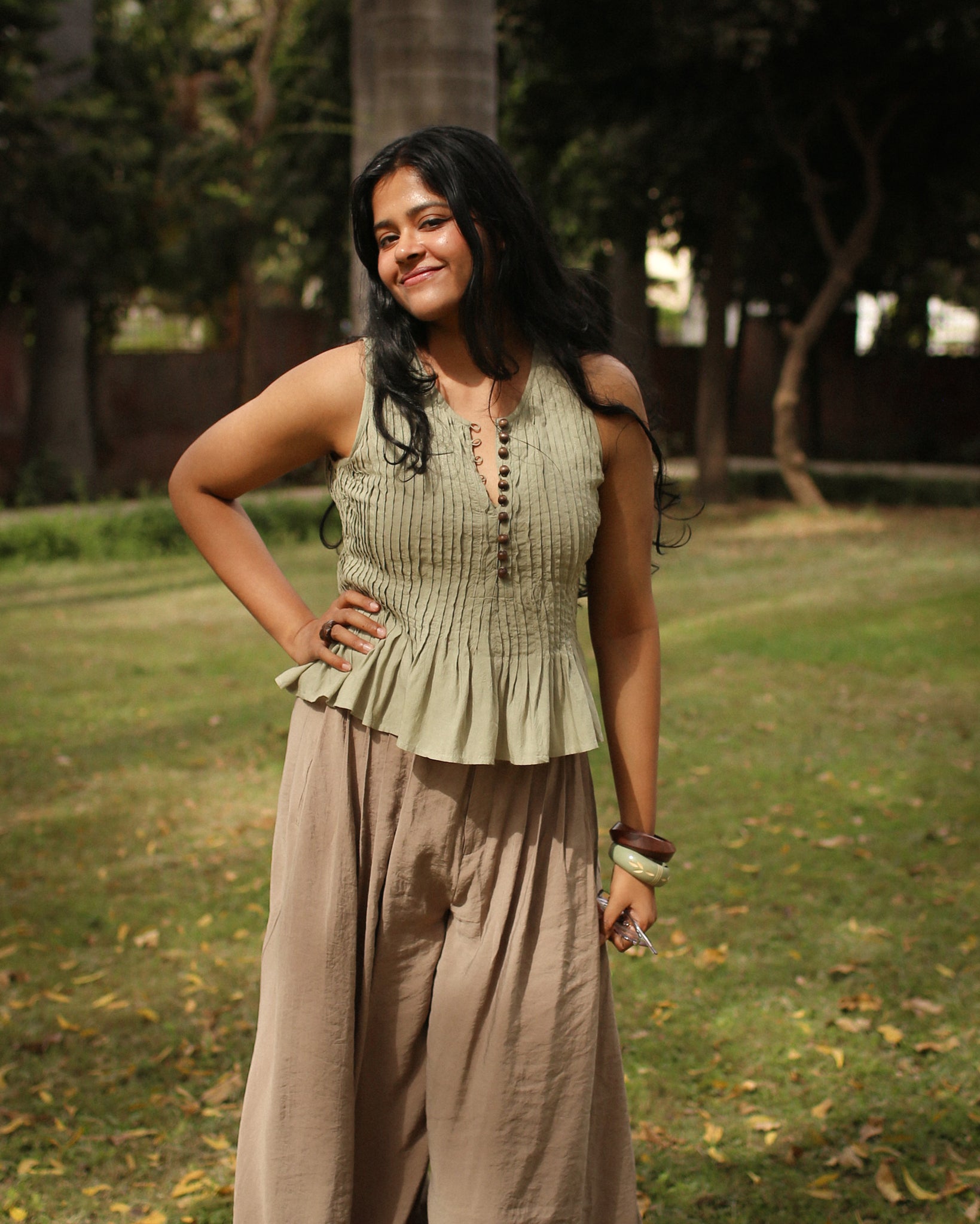 Cotton peplum top showing fitted pleated bodice and flared waist for a flattering silhouette