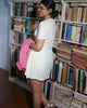 Mid-thigh white textured skort styled with pink shirt